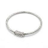 Amali Jules UK sterling silver bangle with a molten texture and five free-moving hammered floating accent rings.